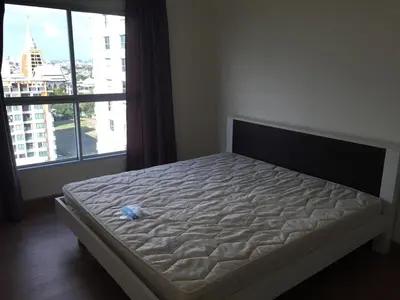 a bed in a room with a large window at SS Sukhumwit in Amphoe Phra Khanong