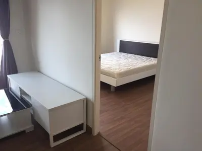 a small room with a bed and a small closet at SS Sukhumwit in Amphoe Phra Khanong