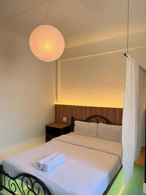 a bedroom with a bed with two towels on it at arakhouse อารักษ์เฮ้าส์ in Godown