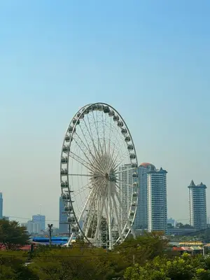 a large ferris wheel in front of a city at arakhouse อารักษ์เฮ้าส์ in Godown