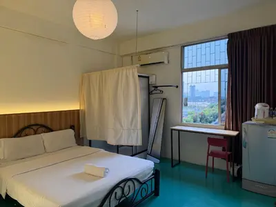 a bedroom with a bed and a large window at arakhouse อารักษ์เฮ้าส์ in Godown