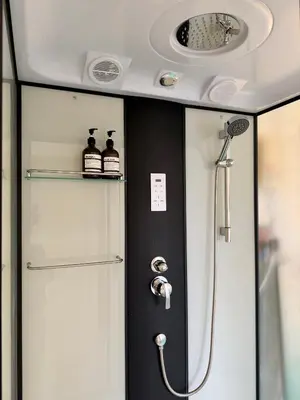 a bathroom with a shower in a vehicle at arakhouse อารักษ์เฮ้าส์ in Godown