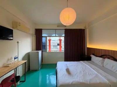 a bedroom with a white bed and a window at arakhouse อารักษ์เฮ้าส์ in Godown
