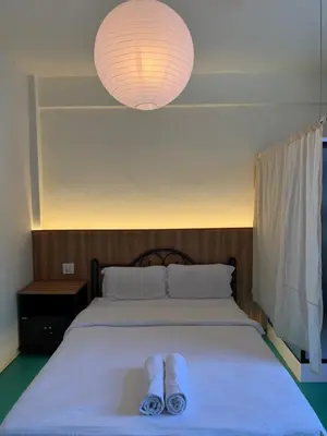 a bed with two pairs of slippers sitting on it at arakhouse อารักษ์เฮ้าส์ in Godown