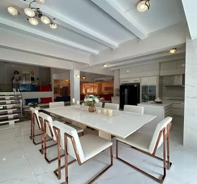 a large kitchen with a large white table and chairs at Residence at 49 in Bangkok