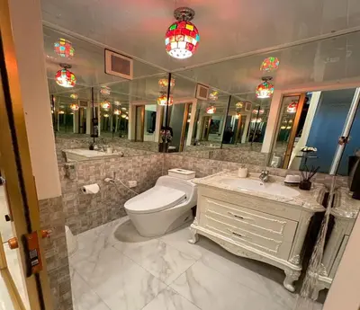 a bathroom with a toilet and a sink and a mirror at Residence at 49 in Bangkok