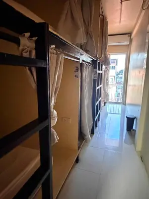 a room with a closet with curtains and a hallway at The Green Bean Hostel Khaosan in Bangkok