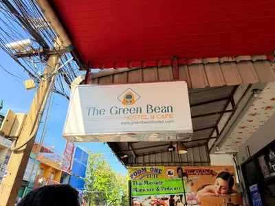 a sign for the green bean hotel and cafe at The Green Bean Hostel Khaosan in Bangkok