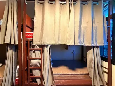 a room with two bunk beds and a ladder at The Green Bean Hostel Khaosan in Bangkok