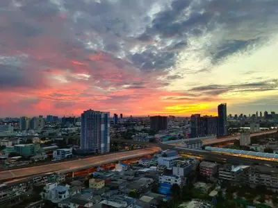 a view of a city with a sunset at Panoramic sky city view 1 BR at MRT Bangson By Orn in Bangkok