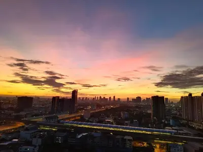 a view of a city at sunset at Panoramic sky city view 1 BR at MRT Bangson By Orn in Bangkok