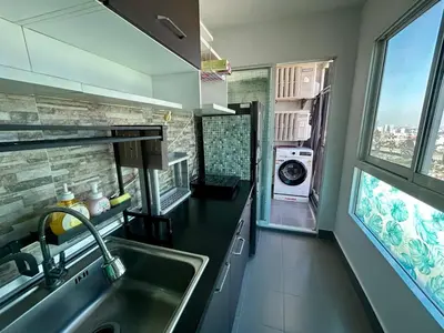 a kitchen with a sink and a washing machine at Panoramic sky city view 1 BR at MRT Bangson By Orn in Bangkok