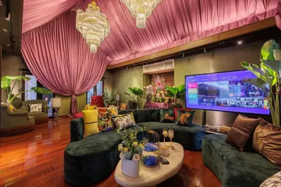 a large living room with couches and a large tv at CBD Private Pool Villa Nanny Free Thai costumes 24hrs Security Breakfast in Bangkok