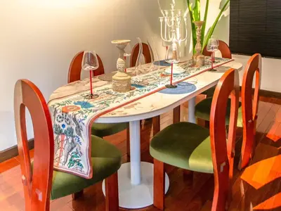 a dining room table with chairs and wine glasses at CBD Private Pool Villa Nanny Free Thai costumes 24hrs Security Breakfast in Bangkok