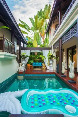 a swimming pool in the middle of a house at CBD Private Pool Villa Nanny Free Thai costumes 24hrs Security Breakfast in Bangkok