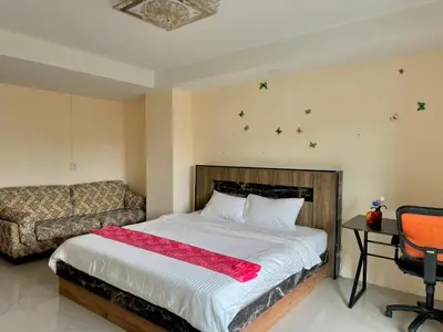 a bedroom with a bed and a couch at Baan Kalaya Homestay in Nonthaburi