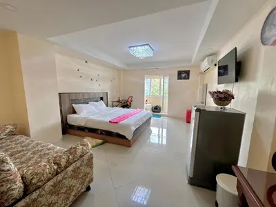 a large bedroom with a bed and a couch at Baan Kalaya Homestay in Nonthaburi