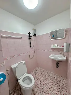 a pink bathroom with a toilet and a sink at Baan Kalaya Homestay in Nonthaburi