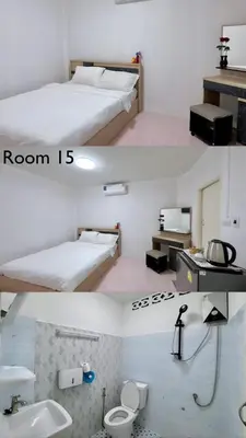 a room with two beds and a bathroom with a sink at Baan Kalaya Homestay in Nonthaburi