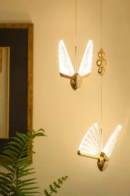 a couple of butterfly lights hanging from a wall at Oasis Thai Teak Home in Sathorn in Yan Nawa