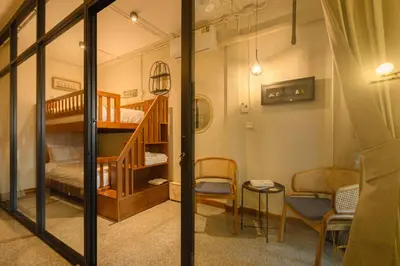 a room with a bunk bed and a staircase at Oasis Thai Teak Home in Sathorn in Yan Nawa