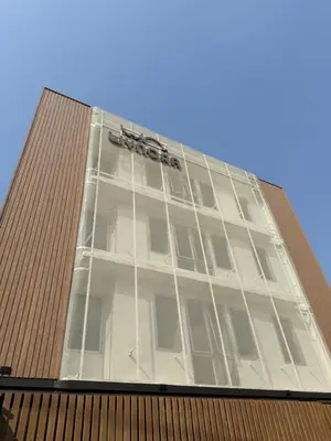 a tall building with a sign on top of it at Wynora Hotel in Khlong Toei