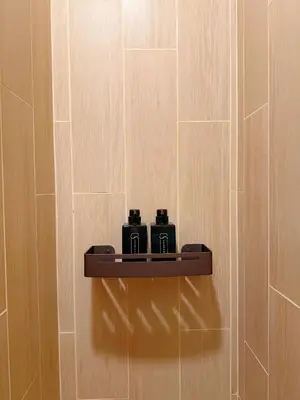 a shelf on a wall with two cameras on it at Wynora Hotel in Khlong Toei