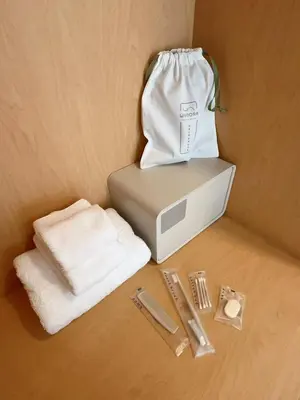 a white bag is sitting on top of a microwave at Wynora Hotel in Khlong Toei