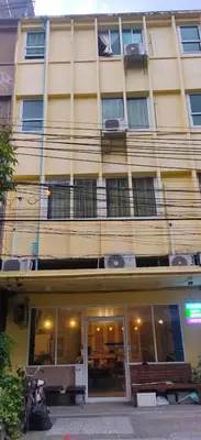 a building with a bench in front of it at Santo house no66 in Bangkok