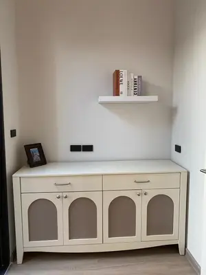 a white cabinet with a shelf and books at 89 Residence Ratchada - Rama 9 in Ban Na Song