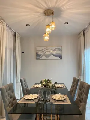 a dining room with a table and chairs at 89 Residence Ratchada - Rama 9 in Ban Na Song