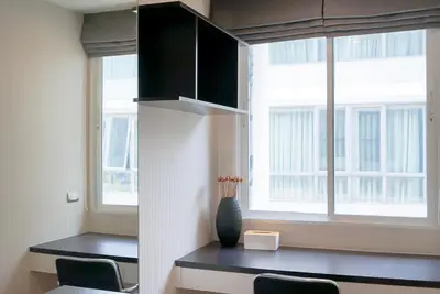 a room with a table with chairs and a window at 5 mins to BTS Ekkamai, One Bed Fully-Furnished in Bangkok
