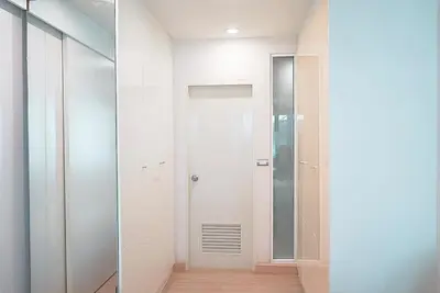 a bathroom with a walk in shower and a mirror at 5 mins to BTS Ekkamai, One Bed Fully-Furnished in Bangkok