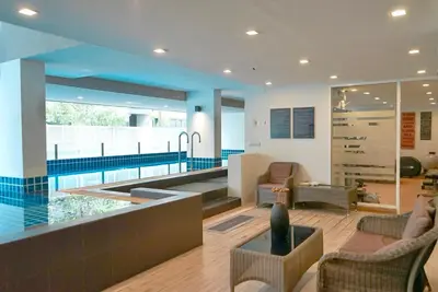 a living room with a swimming pool in a house at 5 mins to BTS Ekkamai, One Bed Fully-Furnished in Bangkok