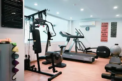 a gym with two exercise bikes and a treadmill at 5 mins to BTS Ekkamai, One Bed Fully-Furnished in Bangkok