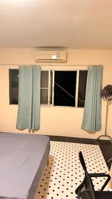 a bedroom with a bed and a window with curtains at \u8f89\u714c\u62c9\u629b3\u5ba4180\u5e73\u7c73\u522b\u5885 in Bangkok