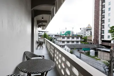 a balcony with two chairs and a table at ดอนเมือง 304 Near DMK Airport BTS Wat PhraSi in Bang Khen