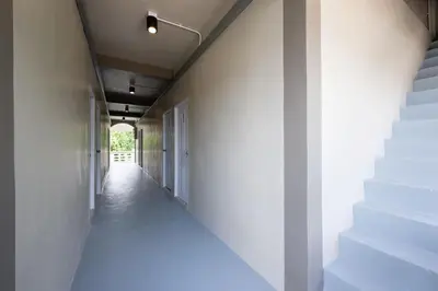 a hallway with white walls and white stairs at ดอนเมือง 304 Near DMK Airport BTS Wat PhraSi in Bang Khen