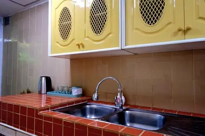 a kitchen with a sink and red tiles at 38 House Don Mueang Airport BTS Wat Phrasi in Bang Khen