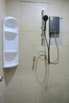 a bathroom with a soap dispenser on a wall at 38 House Don Mueang Airport BTS Wat Phrasi in Bang Khen
