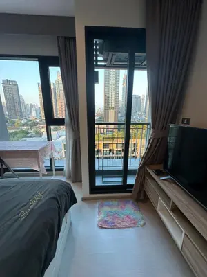 a bedroom with a bed and a large window at BTS Skytrain Thonglor station sukhumwit 36-38 in Bangkok