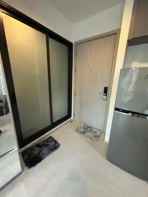 a room with a refrigerator and a large window at BTS Skytrain Thonglor station sukhumwit 36-38 in Bangkok