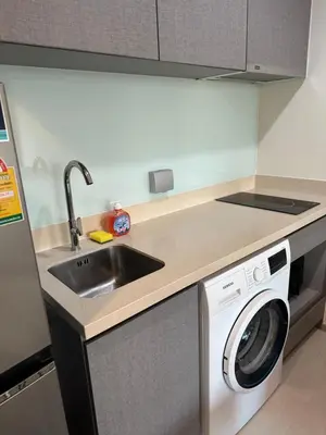 a kitchen with a sink and a washing machine at BTS Skytrain Thonglor station sukhumwit 36-38 in Bangkok