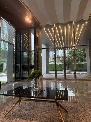 a lobby with a glass table in a building at 2BR Apartment near SiamPlatinumCentral World in Bangkok