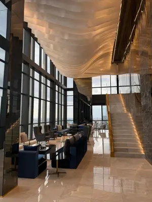 a lobby with couches and tables and windows at 2BR Apartment near SiamPlatinumCentral World in Bangkok