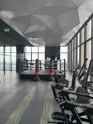 a gym with rows of exercise equipment in a building at 2BR Apartment near SiamPlatinumCentral World in Bangkok