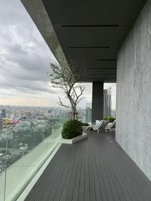 a balcony with a tree on top of a building at 2BR Apartment near SiamPlatinumCentral World in Bangkok