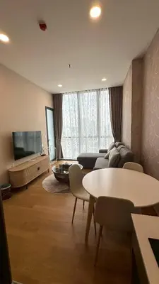 a living room with a couch and a table and a tv at 2BR Apartment near SiamPlatinumCentral World in Bangkok