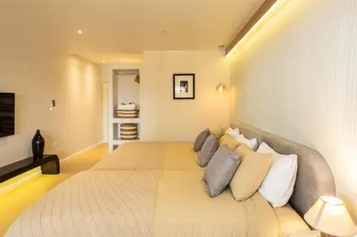 a bedroom with a large bed with pillows at Cute & Comfy Studio for 3 guests at Center of Sathorn in Bangkok