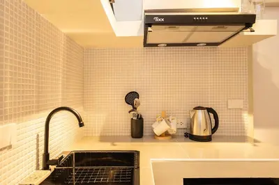 a kitchen with a sink and a counter top at Cute & Comfy Studio for 3 guests at Center of Sathorn in Bangkok